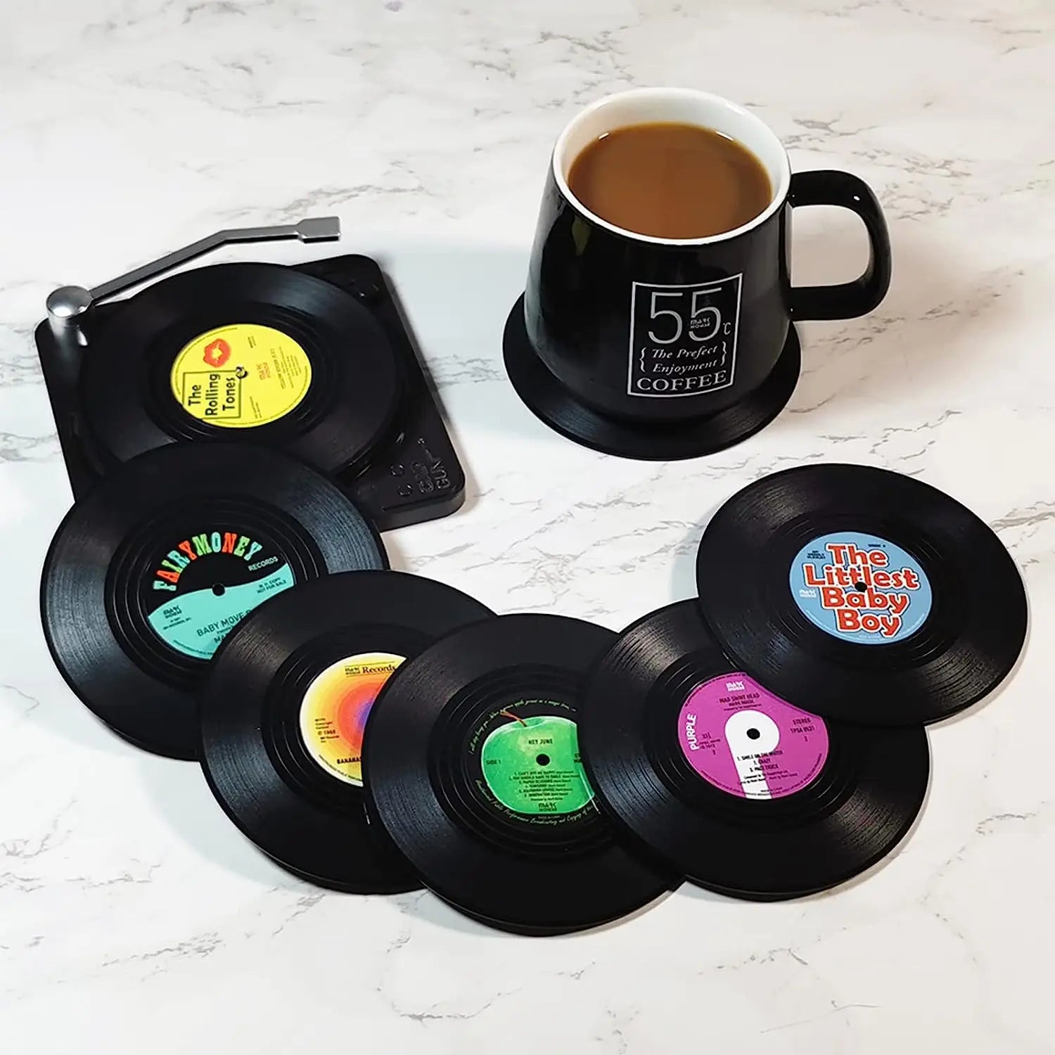 Vinyl record coasters with a coffee cup on a white surface