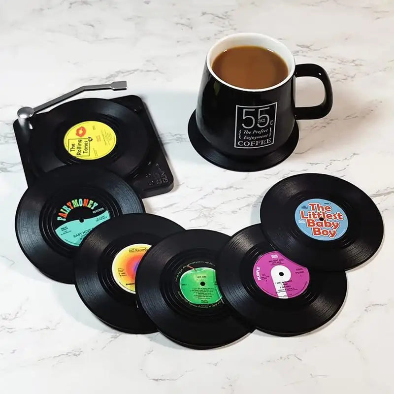 Vinyl record coasters with a coffee cup on a white surface